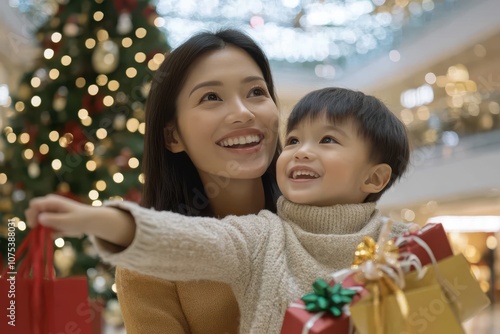 a mother and son in front of a christmas tree