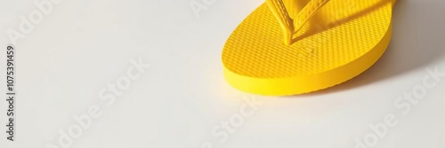 Close-up shot of a yellow flip flop's sole on a white surface, emphasizing its texture and design, sandal strap, footpad photo