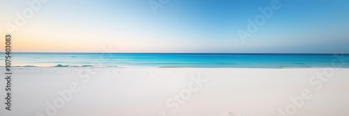 Softly fading light on a pristine white sandy beach with an endless blue horizon, tranquility, natural