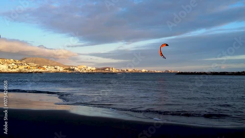 Kitesurfing. Two athletes train on a kite board near the shoreline