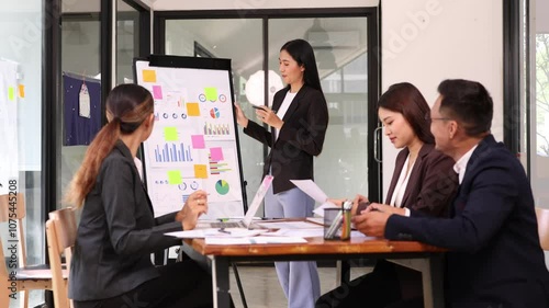 Team of Asian creative business teamwork and startup worker meeting in office. Coworkers young woman team at work, Group of young business working together with analysis report chart in office.