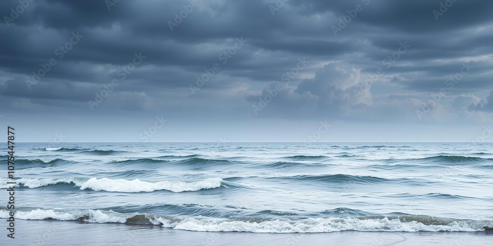 Gentle waves undulate against the shore as clouds gather in the darkening sky, seascapes, horizon line, beach scene Gentle waves undulate against the shore as clouds gather in the darkening sky, seascapes, horizon line, beach scene
