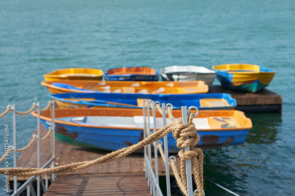 Naklejka premium Pier with boats on the lake shore. Copy space.
