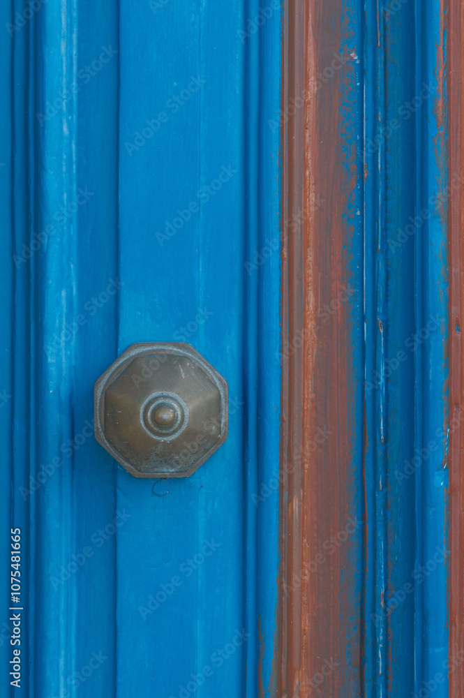 Detail of a blue door with a knob, close up. Detail of a blue door with a knob, close up.