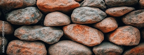 Textured stone wall featuring gray and brown stones arranged in a rustic pattern with space for personal expression or branding photo