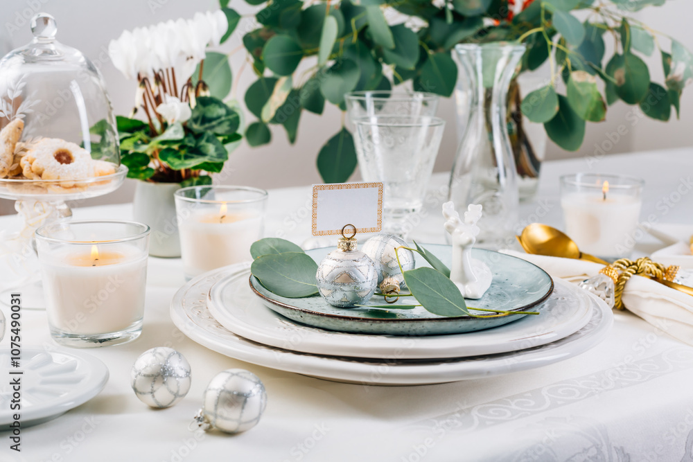 Traditional festive place setting for Christmas, decorated with eucalyptus branch Traditional festive place setting for Christmas, decorated with eucalyptus branch