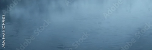 Dark and misty water surface of a lake or pond with subtle ripples and reflections, natural scenery, still water