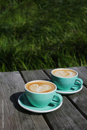 Two beautiful cups with delicious double cappuccino. Beautiful latte art.