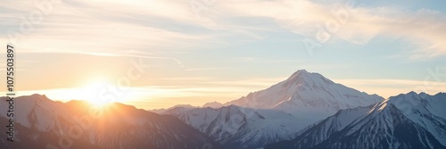 Snow-capped peaks in the distance with a golden glow from the setting sun, autumn landscape, scenic views, alpine scenery