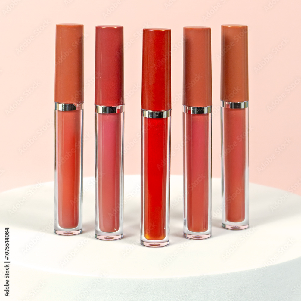 different shades of matte liquid lipstick with white blocks, light pink background and flowers studio shot different shades of matte liquid lipstick with white blocks, light pink background and flowers studio shot
