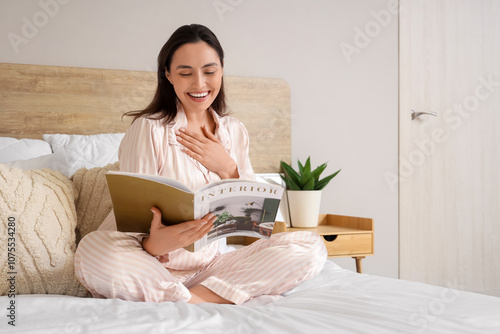 Young woman in pajamas read...