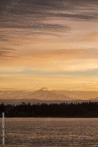 Mt. Baker during a colorful and dramatic sunrise looking across Hale Passage in the Salish Sea area of western Washington state. Seen from Lummi Islands east side during the minutes before sunrise.