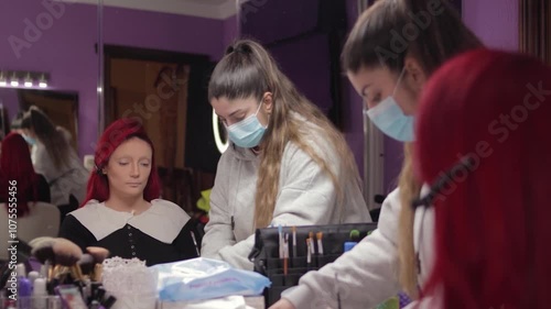 Makeup Artist Applying Character Makeup to Redhead Woman – Mid Shot Reflected in Mirror. Maquilladora Aplicando Maquillaje de Caracterización a Mujer Pelirroja – Plano Medio Reflejado en el Espejo
