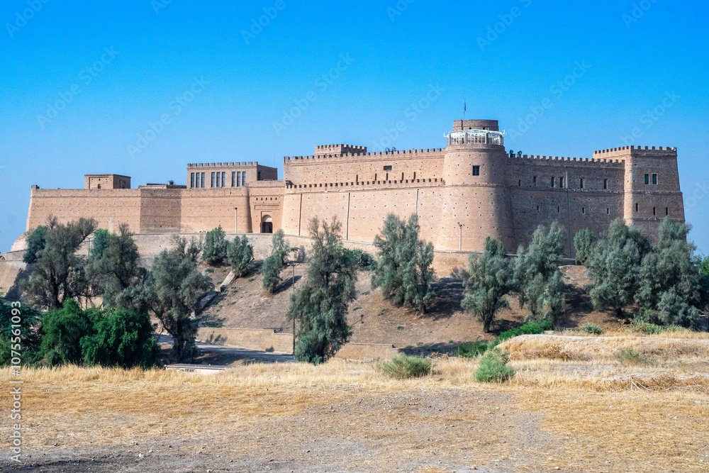 A large castle sits atop a hill, surrounded by trees and greenery, Shush, Iran A large castle sits atop a hill, surrounded by trees and greenery, Shush, Iran
