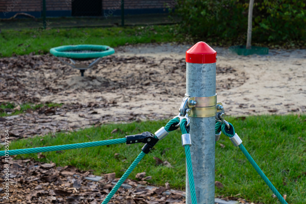Colorful playground equipment at a park by the grassy area Colorful playground equipment at a park by the grassy area