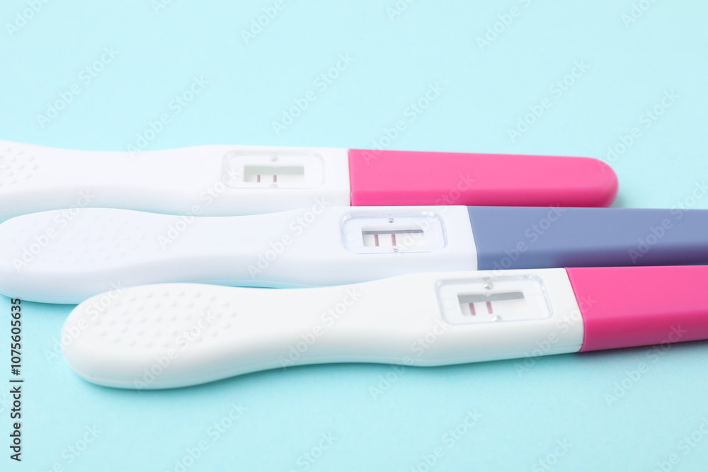 Pregnancy tests on light blue background, closeup Pregnancy tests on light blue background, closeup