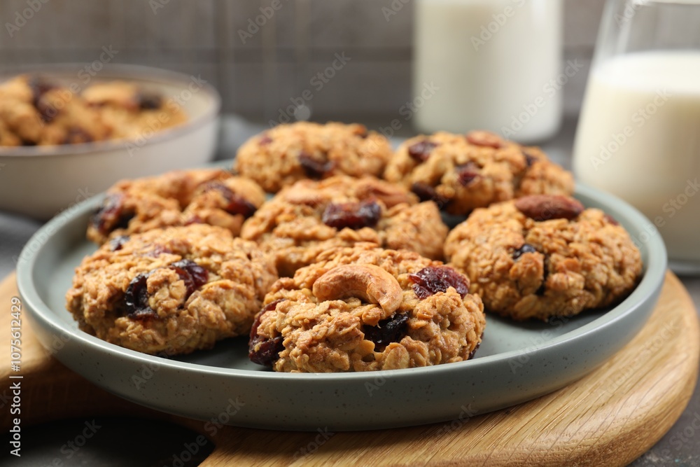 Delicious oatmeal cookies with raisins and nuts on table, closeup Delicious oatmeal cookies with raisins and nuts on table, closeup