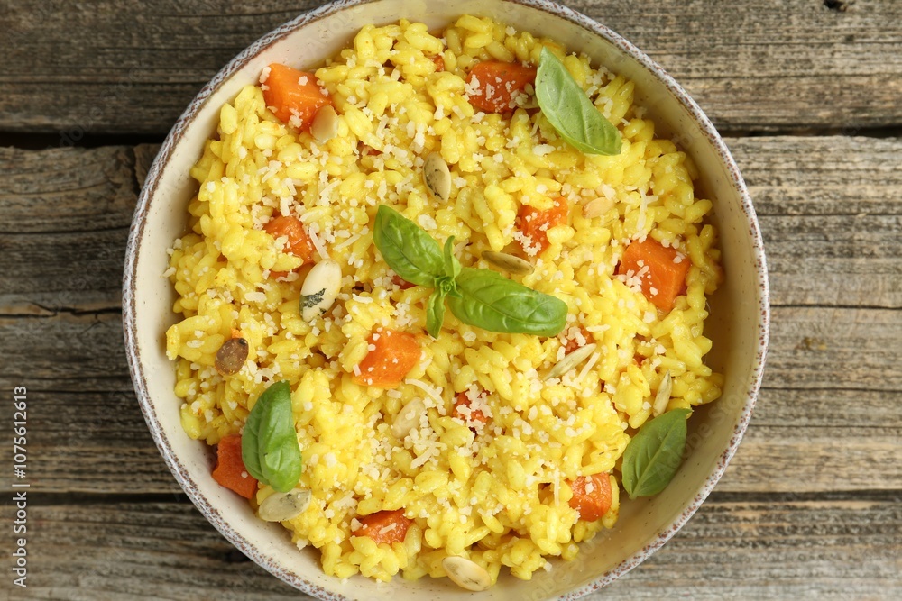 Delicious pumpkin risotto in bowl on wooden table, top view Delicious pumpkin risotto in bowl on wooden table, top view