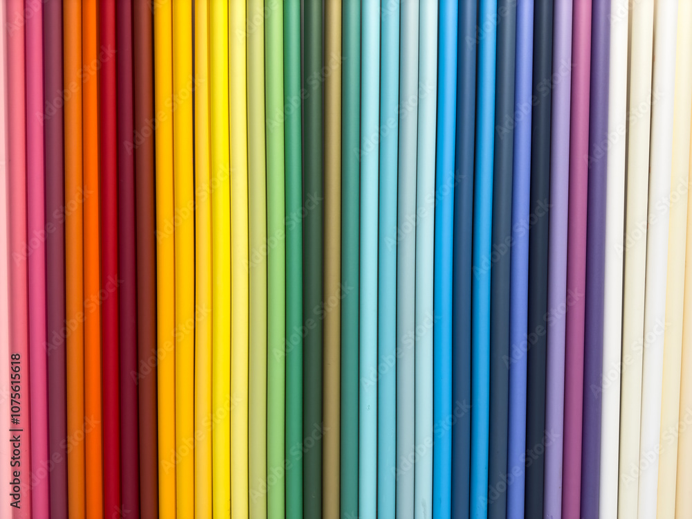 A row of colorful fabric rolls, each with a different color