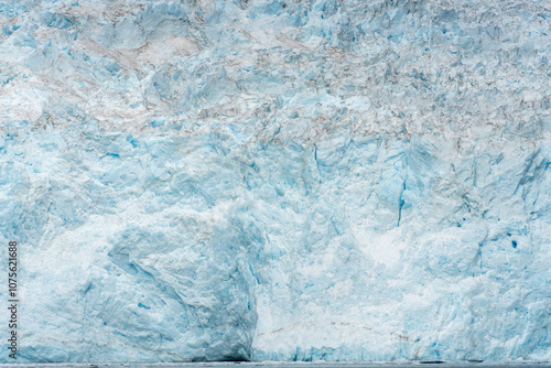 Towering glacial ice formation with crevasses and cracks
