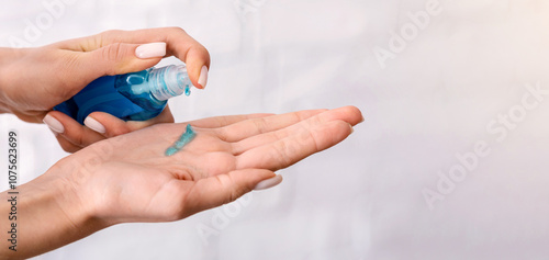 Disinfection during 2019-ncov epidemic. Woman rubs hands with antiseptic