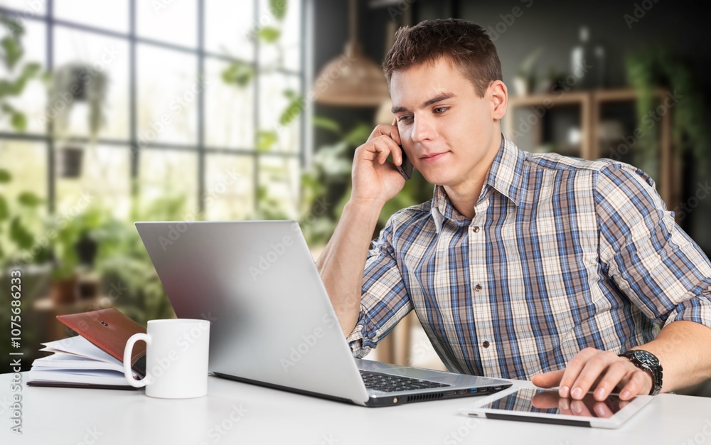 Happy handsome entrepreneur man work on laptop at home Happy handsome entrepreneur man work on laptop at home