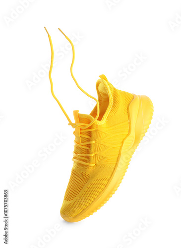 One stylish yellow sneaker isolated on white photo