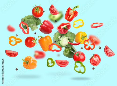 Wallpaper Mural Many different fresh vegetables in air on light blue background Torontodigital.ca