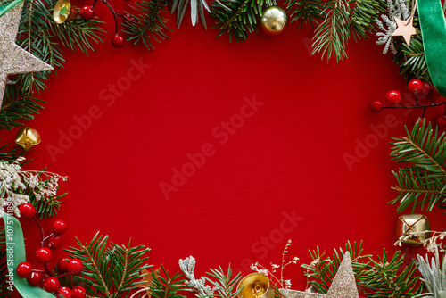 Wallpaper Mural Christmas flat lay. Green fir branches, red berries, ribbon and golden ornaments on red background. Merry Christmas. Stylish christmas frame with space for text. Xmas background Torontodigital.ca