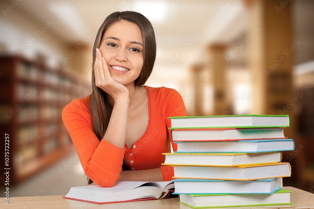 Portrait of adult business woman or teacher sitting in library Portrait of adult business woman or teacher sitting in library