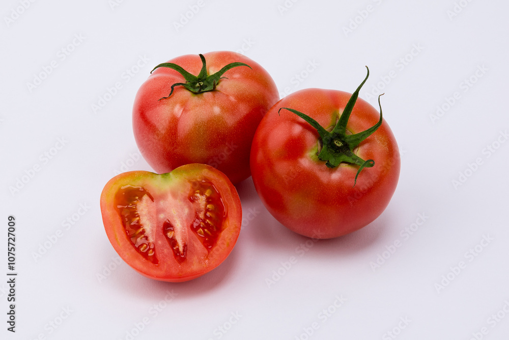 Close-up of fresh tomatoes on white background. Close-up of fresh tomatoes on white background.