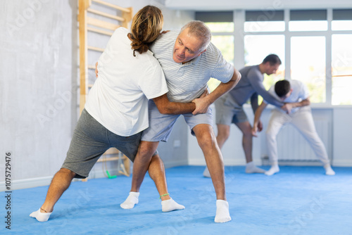 Male and senior man athletes during classes, training improve and practice wrestling with opponent in technique of martial arts. Work on yourself, increase endurance, determination, courage