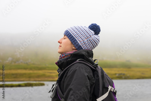 Serene woman relaxing in the cold mountains landscape photo