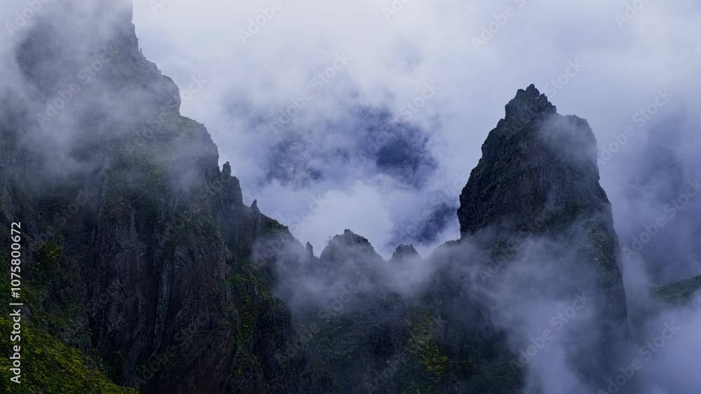 A mountain covered in fog with moving clouds. Near Pico de Arieiro , Madeira island, Portugal A mountain covered in fog with moving clouds. Near Pico de Arieiro , Madeira island, Portugal