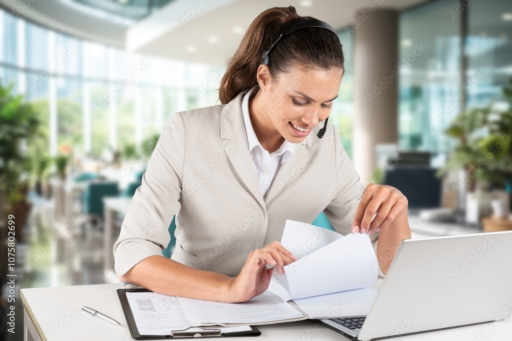 Focused young business worker working on laptop
