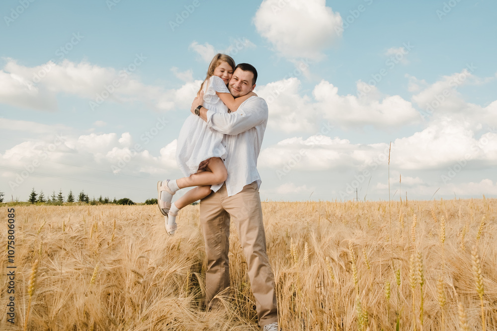 Happy child and dad hugging in a rye field. Happy child and dad hugging in a rye field.