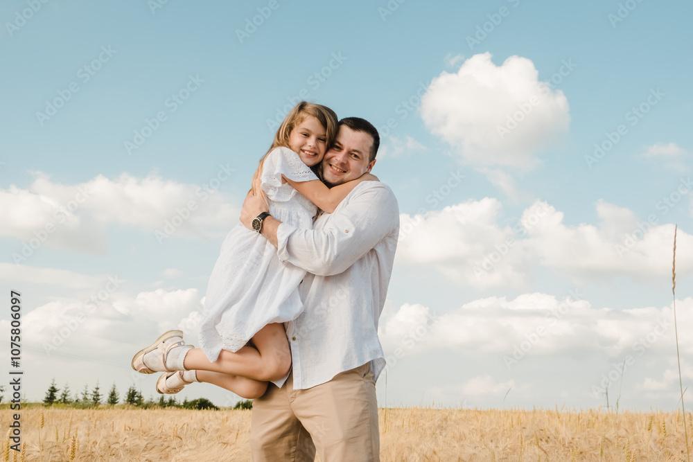 Dad with daughter in the field.Beautiful daughter kisses and hugs her dad. Dad with daughter in the field.Beautiful daughter kisses and hugs her dad.