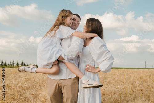 Happy cheerful family on vacation. Mom, and three children are playing, hugging.