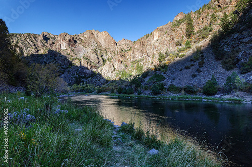 Deep shadows and canyon wall of the Gunnison River with a cloudless blue sky in Black Canyon of the Gunnison National Park Colorado, USA. photo