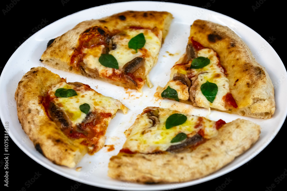 Anchovy pizza isolated on black background top view Anchovy pizza isolated on black background top view