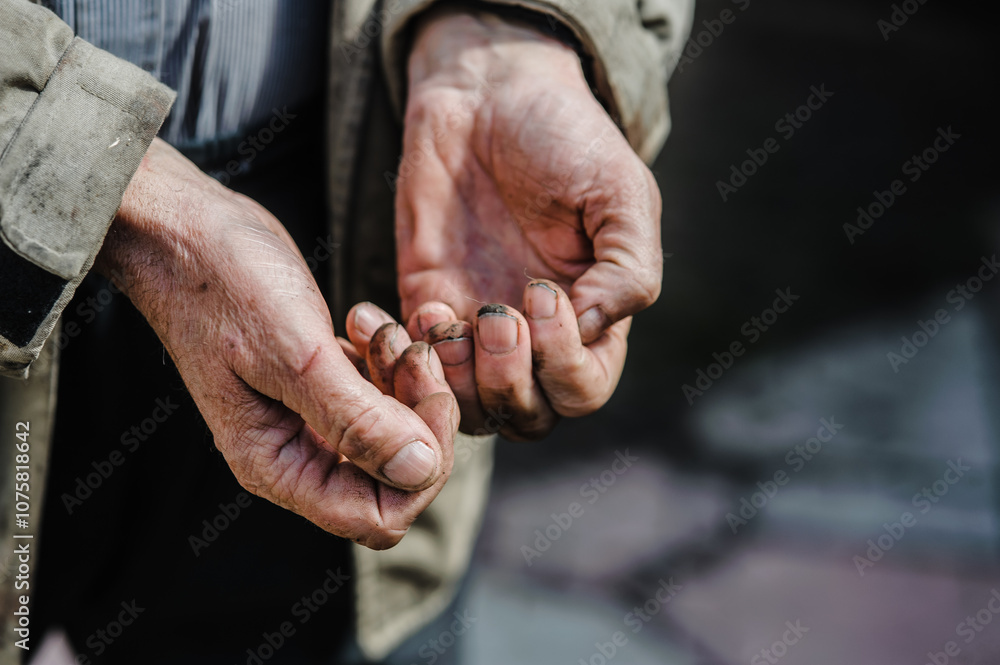 Fototapeta premium Dirty hands of a worker working on the ground. Close-up of a person's dirty hands. Agricultural work.
