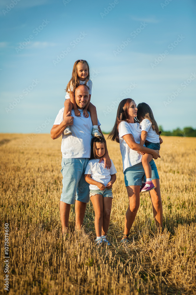 Children are having fun playing.Happy cheerful family in nature, weekend. Dad, mom and three children all in clothes, having a good time. Concept of a strong family. Emotions of happiness. Children are having fun playing.Happy cheerful family in nature, weekend. Dad, mom and three children all in clothes, having a good time. Concept of a strong family. Emotions of happiness.