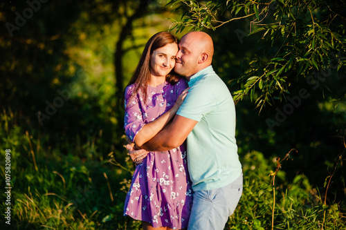 A young married couple smiling in nature