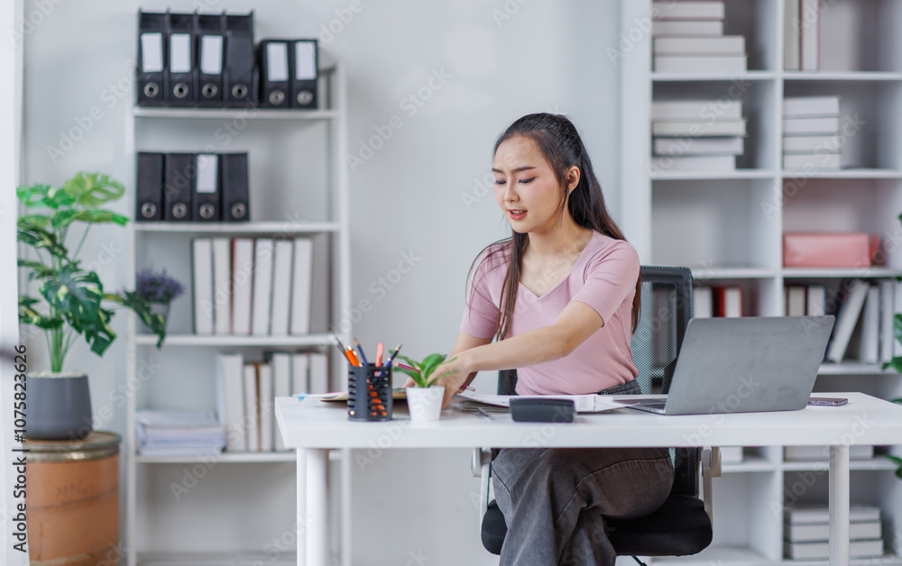 Asian Businesswoman Using laptop computer and working at office with calculator document on desk, doing planning analyzing the financial report, business plan investment, finance analysis concept.
Asian Businesswoman Using laptop computer and working at office with calculator document on desk, doing planning analyzing the financial report, business plan investment, finance analysis concept.