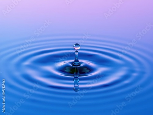 A droplet of colorful ink falls onto the surface of the water creating a small, rounded depression with a ripple effect, reflection, depression