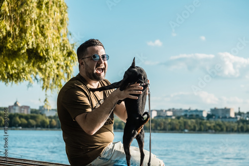 The dog is playing with the dog by the lake.