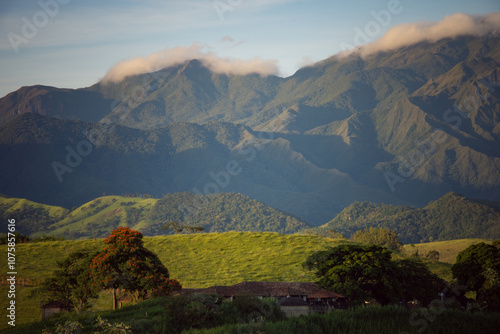 Rolling green hills and rugged mountains at sunset in Cruzeiro, SP.