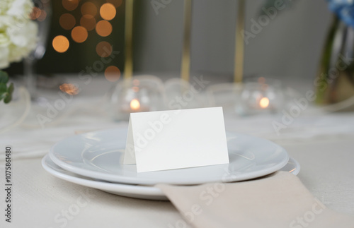 Mockup white blank space card, for Name place, Folded, greeting, invitation on wedding table setting background. with clipping path