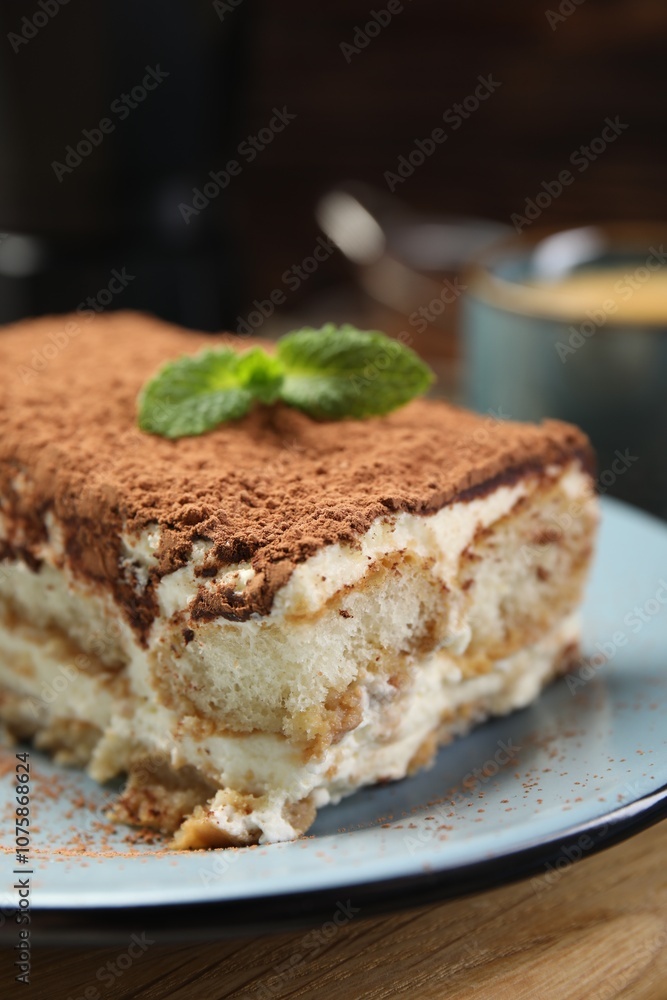 Piece of tasty tiramisu on wooden table, closeup Piece of tasty tiramisu on wooden table, closeup