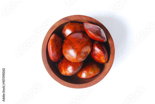 Dogfruit (Archidendron pauciflorum) an Indonesia commonly called djenkol, jengkol or jering on a small wooden bowl isolated on white background. Food Ingredients photo